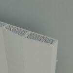 Modern white radiator with intricate grille design, ideal for contemporary heating solutions.