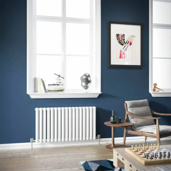Modern living room with navy blue walls, large windows, and stylish decor for a cozy atmosphere.