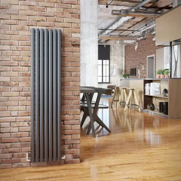Radiator heater mounted on brick wall in modern loft apartment, stylish interior design, warm wooden floors.