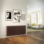 Modern living room interior with stylish wall art and radiator, bright natural light, cozy sofa, and contemporary decor.