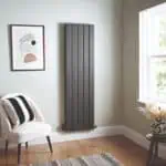 Modern grey vertical panel radiator for home heating, stylish and space-saving design.
