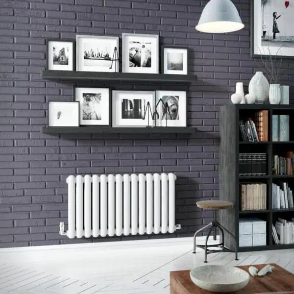 Modern interior home decor with black and white framed photos on purple brick wall, stylish shelving and radiator, cozy living space design.