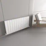 Radiator installation in modern minimalist living room, sleek white panel heating system.