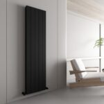 Radiator heater on modern white wall interior with minimalist decor.