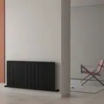 Radiator with modern black design in minimalist interior decor.