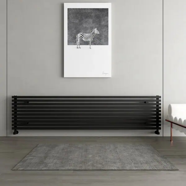 Modern black slatted radiator in a minimalist room.
