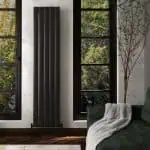 Modern black vertical radiator in a stylish interior setting.