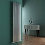 Radiator on a green wall in modern interior decor, part of Poshrads radiator collection in the UK.