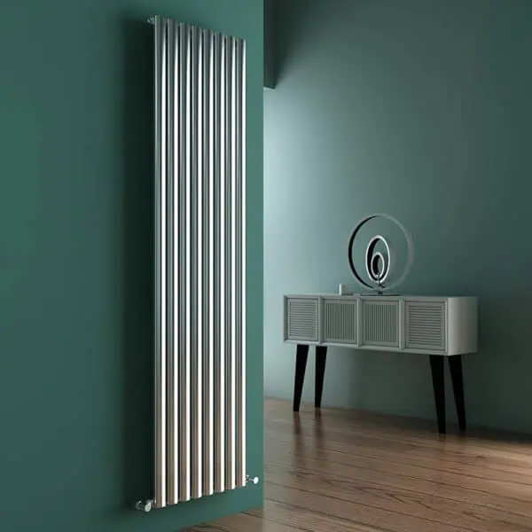 Radiator on a green wall in modern interior decor, part of Poshrads radiator collection in the UK.