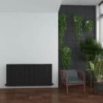 Modern interior with black radiator and lush green plant decor, stylish living space design.