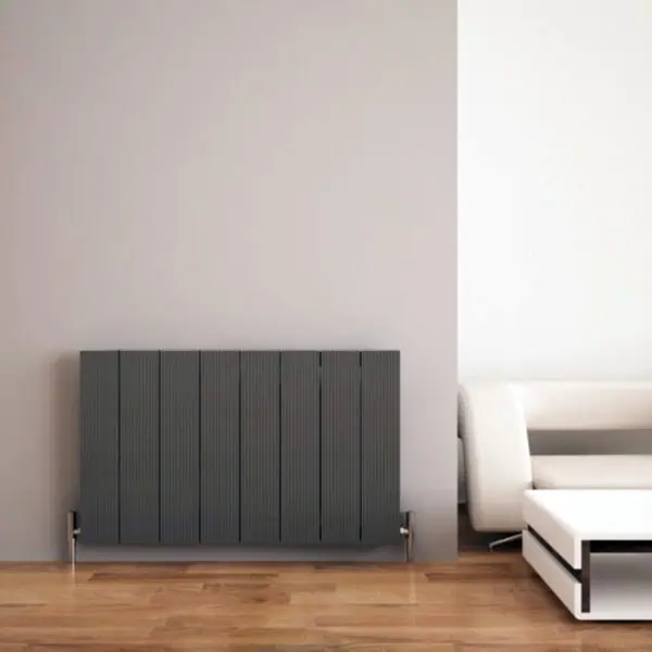 Modern radiator and stylish white sofa in contemporary living room.