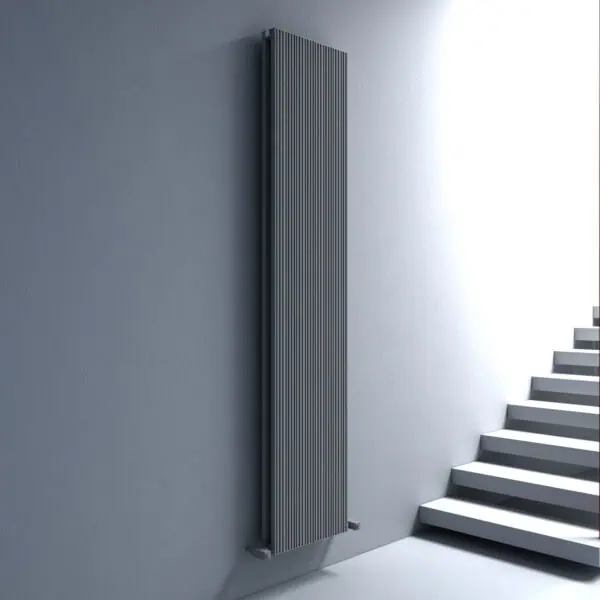 Sleek black modern radiator mounted on a gray wall near staircase, stylish home heating solution.