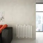 Modern white vertical radiator in minimalist interior setting for stylish home heating solutions.