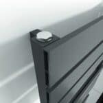Bolt securing a modern aluminum radiator for HVAC system installation.