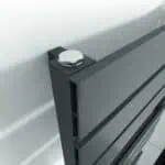 Bolt securing a modern aluminum radiator for HVAC system installation.