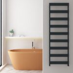 Modern copper freestanding bathtub in minimalist bathroom with black towel radiator and neutral decor.