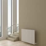Modern radiator in a bright, contemporary interior with large windows and natural light.