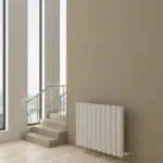 Modern radiator in a bright, contemporary interior with large windows and natural light.
