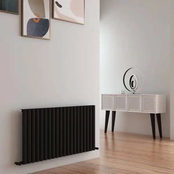 Modern black radiator and stylish white sideboard with decorative objects in contemporary living space.