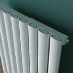 Radiator with white panels and grey top, modern heating system, energy-efficient radiator design.