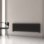 Radiator heating system in modern minimalist interior room, black wall panel radiator design, energy-efficient home heating, black radiator elegance, sleek heating solution.