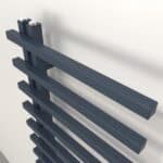 Slim black radiator with modern design, wall-mounted heating panel, sleek home heating solution.