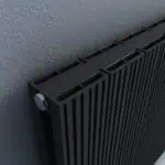 Modern black vertical radiator with a sleek design, ideal for contemporary heating solutions.