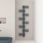 Contemporary wall-mounted radiator in a modern minimalist bathroom, dark grey finish.
