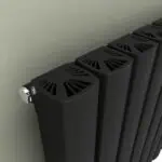 Vintage black radiator with modern design and vented cover.