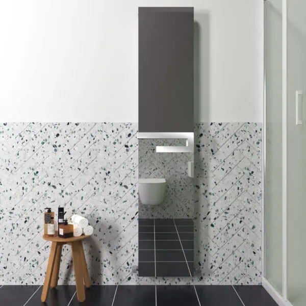 Shower room with modern grey storage cabinet and terrazzo wall tiles.