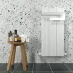 Vibrant bathroom with terrazzo tiles, wooden stool, and white radiator, ideal for modern interior design.