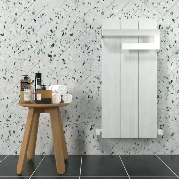Vibrant bathroom with terrazzo tiles, wooden stool, and white radiator, ideal for modern interior design.