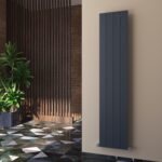 Modern vertical radiator in an interior setting with contemporary decor and patterned flooring.