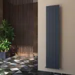 Modern vertical radiator in an interior setting with contemporary decor and patterned flooring.