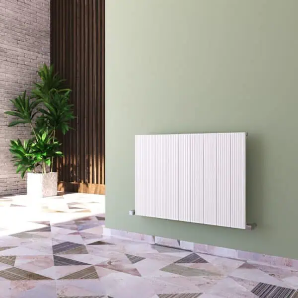 Modern white panel radiator installed on a pastel green wall in a stylish interior setting.