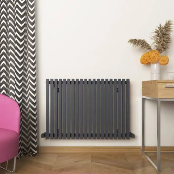 Radiator heating panel in modern interior living space with decorative vase and flowers.