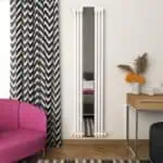 Modern vertical radiator with a mirror in a contemporary living room setup.