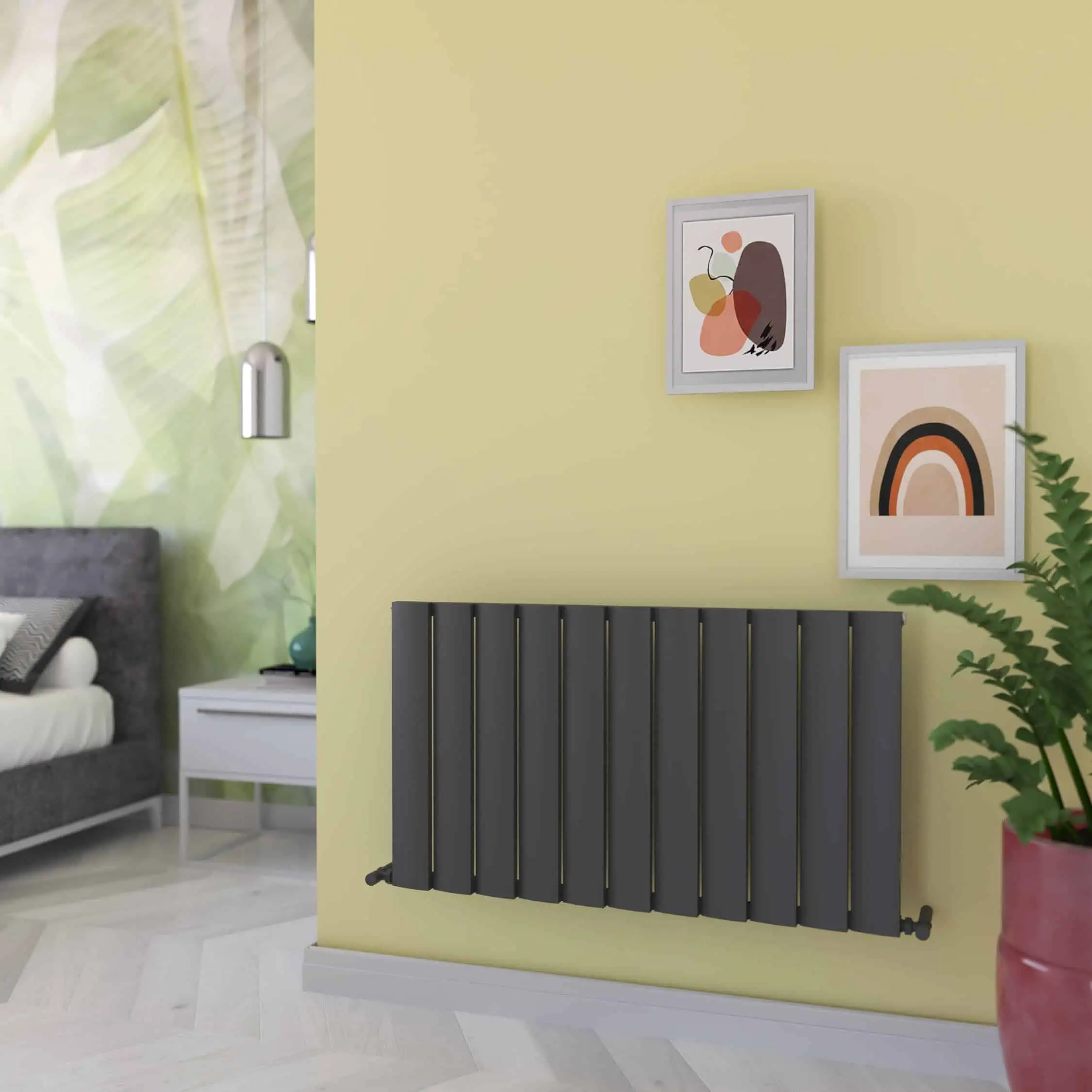 step 1040x600 txg-min Modern black radiator in stylish interior setting with pastel artwork and houseplant.