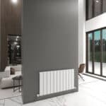 Modern interior with a sleek white radiator on a gray wall in a bright living space.