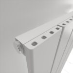 Highly detailed white radiators with multiple outlets for heating systems.