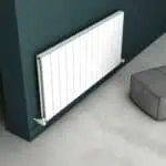 Radiator installation in modern living room, clean white panel radiator on dark wall, heating system, stylish home decor.