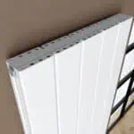 Efficient modern white radiator with adjustable valves, ideal for home heating solutions.