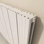 Modern white radiator for home heating systems with adjustable valve.
