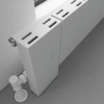 Radiator with modern design, slim profile, and adjustment controls in a contemporary interior.