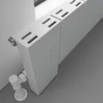 Radiator with modern design, slim profile, and adjustment controls in a contemporary interior.