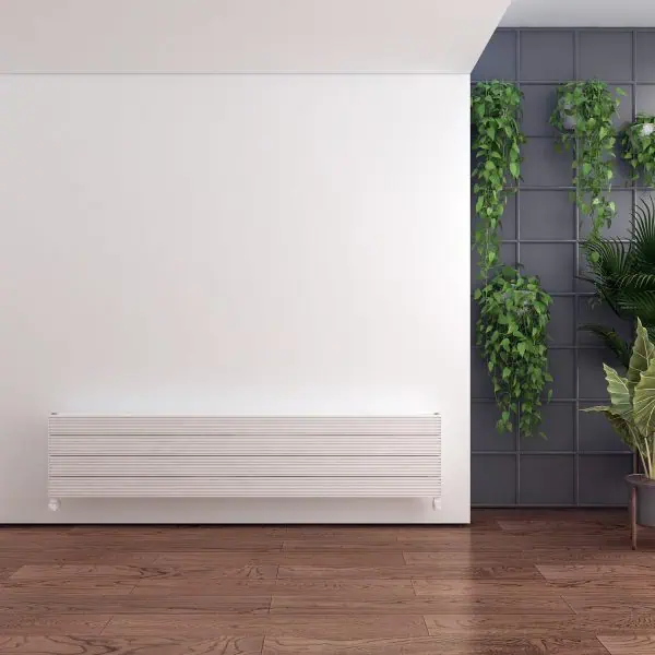 Modern interior with sleek white radiator and green plants, stylish home decor and wood flooring.