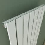 Quiet radiator in modern interior, heating system, home décor, grey wall background.
