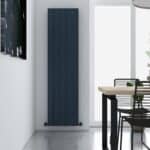 Sleek modern black vertical radiator in minimalist dining room, contemporary home decor, energy-efficient heating solution, stylish interior design.