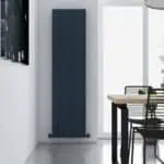 Sleek modern black vertical radiator in minimalist dining room, contemporary home decor, energy-efficient heating solution, stylish interior design.