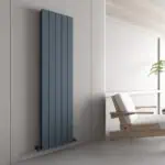 Contemporary vertical radiator in blue installed in a modern minimalist living space.